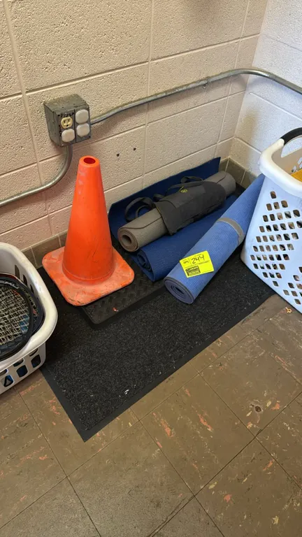 Exercise equipment lot. Includes (3) rolled yoga and exercise mats, (1) Gaiam zippered carrier, (1) orange plastic safety cone, and (1) black textured