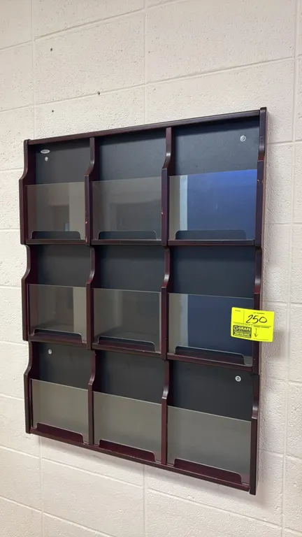 Safco wall-mounted laminate brochure holder. Features 9 literature pockets arranged in a 3x3 grid with clear plastic front panels and a mahogany-finis