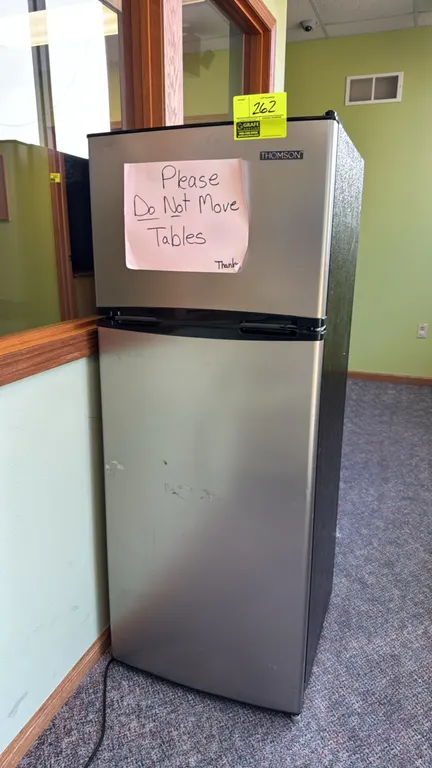 2021 Thomson TFR725 top-freezer refrigerator. Features stainless steel look doors, black cabinet, adjustable glass shelves, a crisper drawer, and door