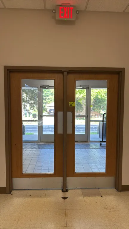 Bulk lot of various interior doors located within the designated wing. Includes double wood doors with glass panels, single flush wood doors, wood doo