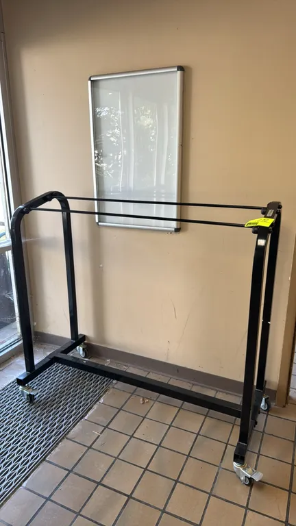 Power Systems portable metal rack. Features a black-finished metal frame with dual hanging bars. 54"L. Mounted on swivel casters, including two lockin