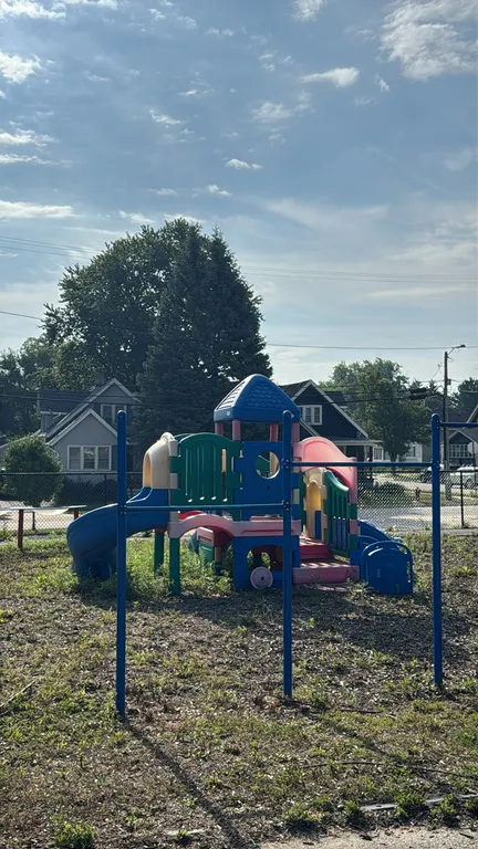 Polyethylene playground station. Multi-colored plastic construction features multiple elevated platforms, a curved slide, double straight slides, prot