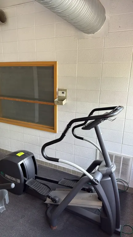 Precor EFX 546 elliptical workout machine. Features an adjustable CrossRamp incline system, stationary handlebars, and a digital display console. Equi