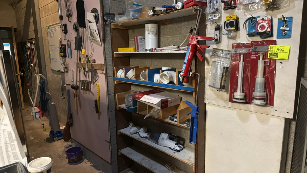 Assorted maintenance items. Includes packaged toilet flush valves, caulk guns, PVC fittings, hand tools (including hammers, pipe wrench, hacksaw, scre