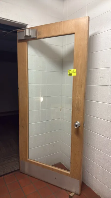 Assorted interior doors. Includes approximately 20 doors in various styles, including solid wood flush doors, wood doors with glass panels and louvers