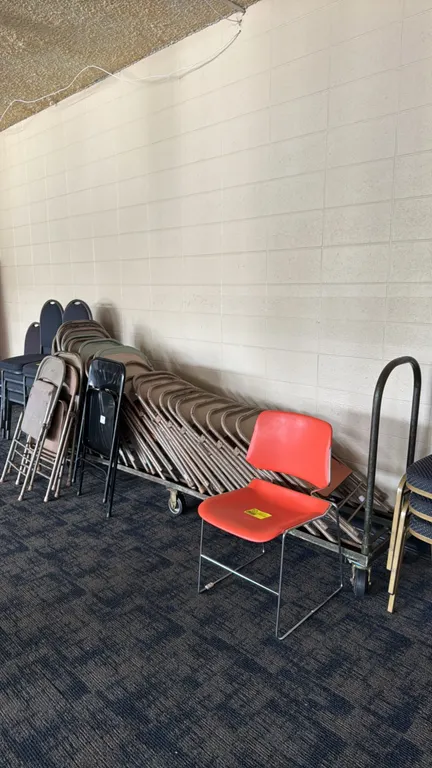 Metal folding chairs. Features steel frames with assorted finish colors including tan, green, and black. Includes a rolling metal chair rack on caster