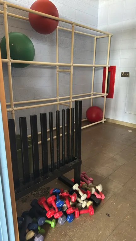 Fitness room equipment package. Includes a variety of rubberized dumbbells with a metal vertical rack, a PVC multi-tier rack with stability balls, a p