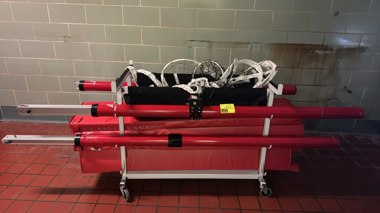BSN Sports volleyball system with a Gared mobile storage cart. Includes adjustable telescopic volleyball posts, red vinyl protective padding, and voll