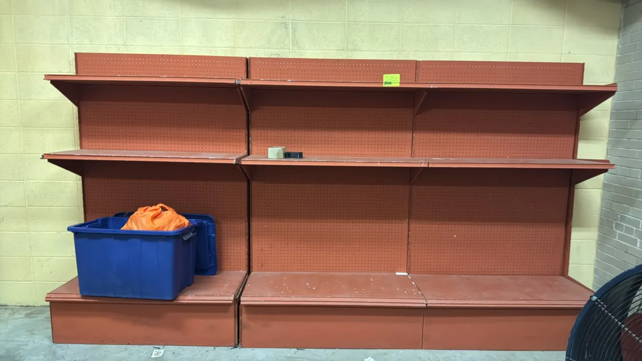 12'L of metal gondola wall shelving. Features a red-orange finish, pegboard backing, 24"D base shelves, and two levels of upper shelves. Dimensions: 1