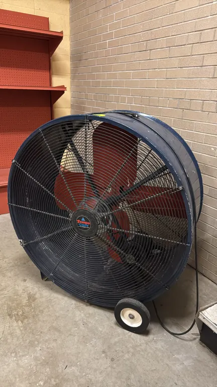 TempaCure 42" metal portable floor fan. Features a blue-finished metal barrel housing, four red fan blades, and protective wire grates. Equipped with