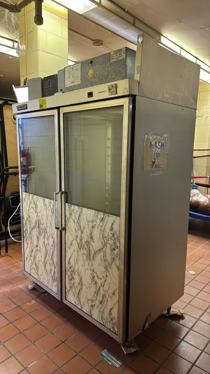 Hobart Q2-4 self-contained 2-door refrigerator. Features stainless steel construction, top-mounted refrigeration system, and doors with glass upper ha