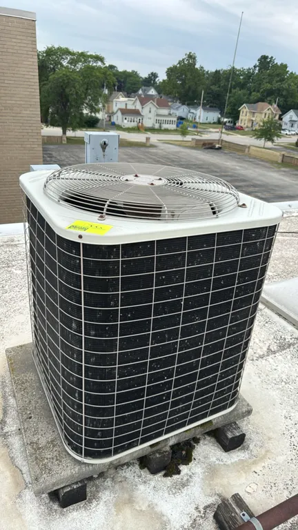 Bryant 561CJ060-A rooftop air conditioner condensing unit. Labeled for R-22 refrigerant. Features top-discharge fan design and includes attached elect