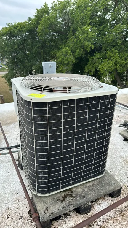 Bryant 561CJ060-A air conditioner condenser unit. Features R-22 refrigerant system. S/N: 3400E14677. Electrical: 208/230V, 60 Hz, 1-Phase. Mounted on