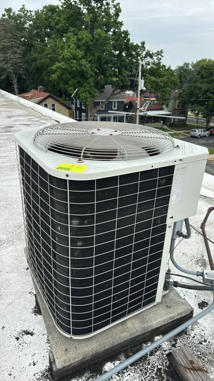 Bryant 561CJ060-A central air conditioning condensing unit. Features a top-discharge design with fan guard and R-22 refrigerant system. S/N: 1200E2545