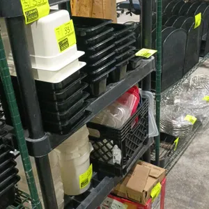 Poly shelving unit. Features durable black plastic construction with a four-tier design. Dimensions: 34"x24"x57". Contents not included.