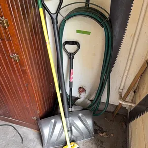 Garden hose and holder, shovels, broom. Note: does not include saw.