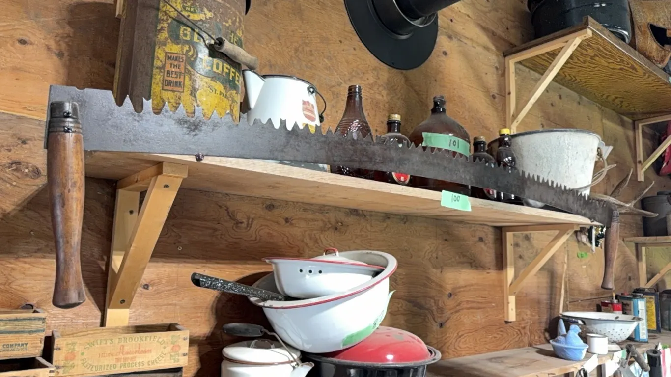 Antique two man saw. Note: Saw only, less items in background, they are selling but on different lots