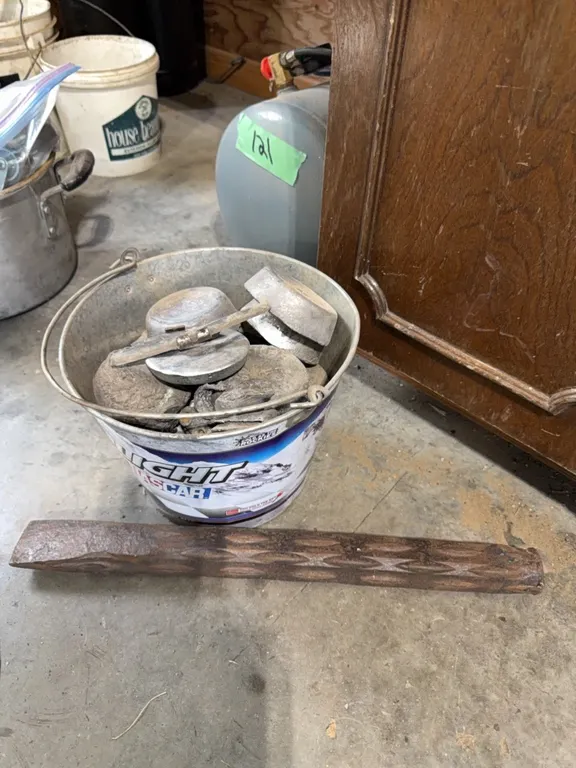 Pail full of lead, includes very large old chisel