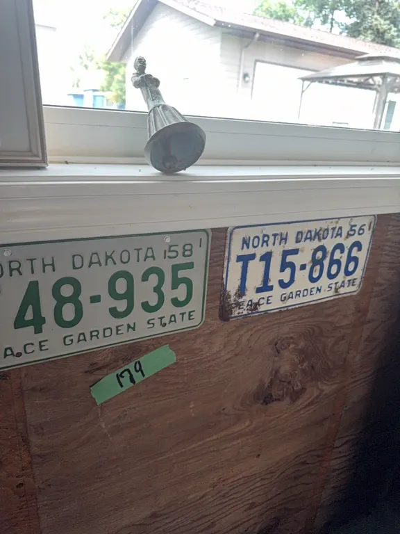  three license plates, picture, and bell