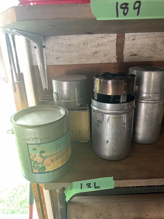 Vintage metal honey container, two vintage camp stores