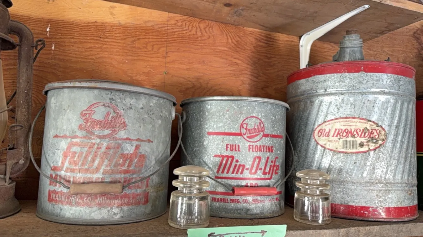 (2) Frabill full floating minnow buckets, also original “old ironsides” gas can, two insulators
