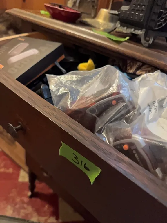 Left top drawer of dresser, belt, hip packs, rechargable hand warmers, walkie talkies