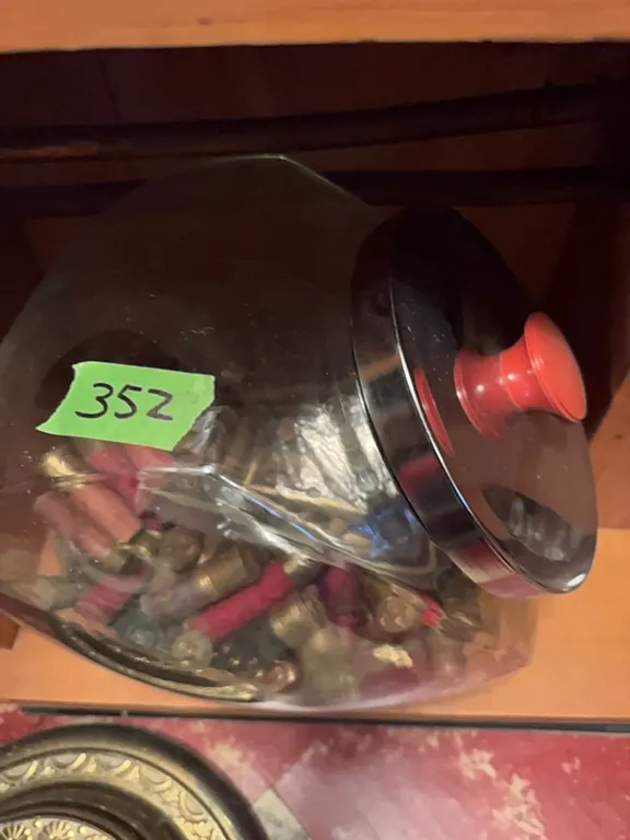 large glass jar with lots of ammo, primarily shot gun shells