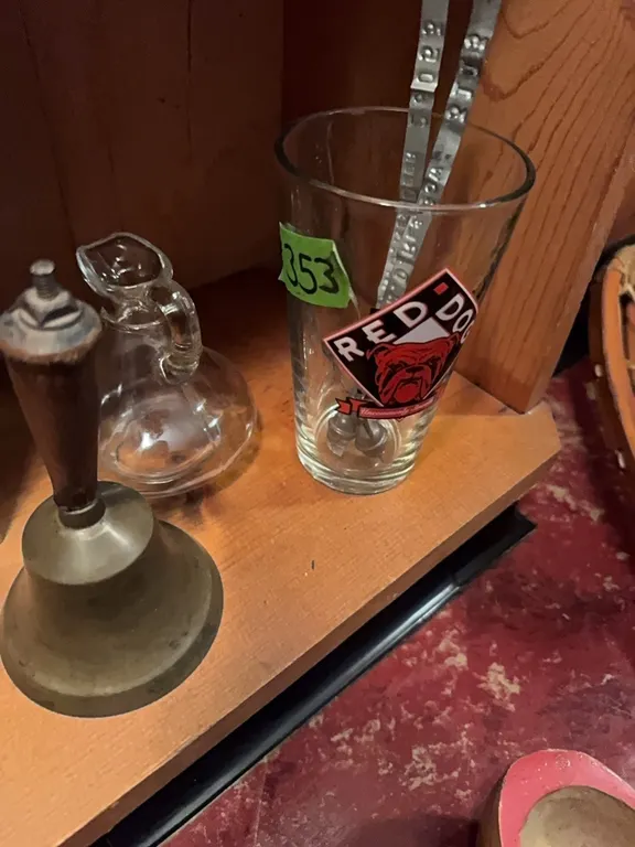 brass bell, Red Dog wine glass, glass pitcher