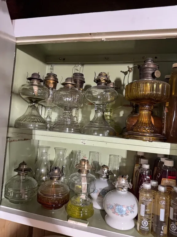 Large collection of antique lanterns, oil, chimneys
