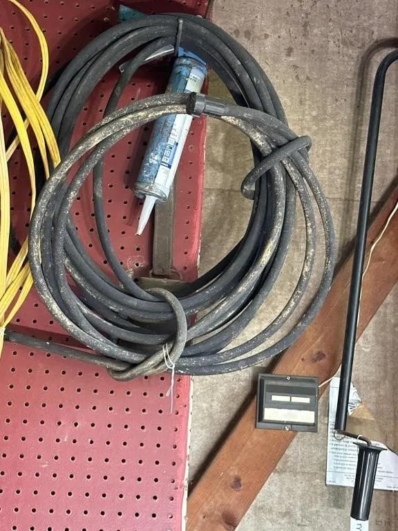 Water hose. Black and caulk gun