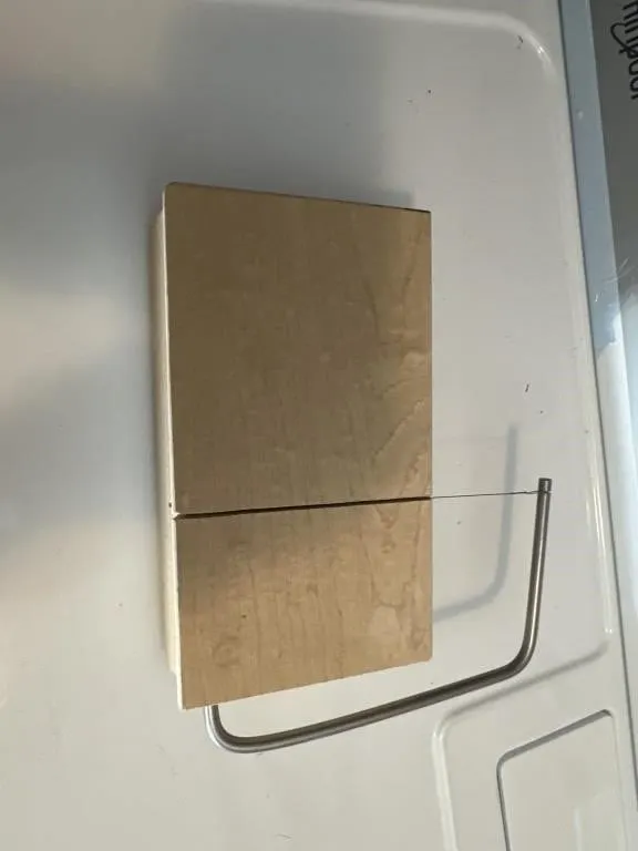 wire cheese cutter board featuring a maple wood
