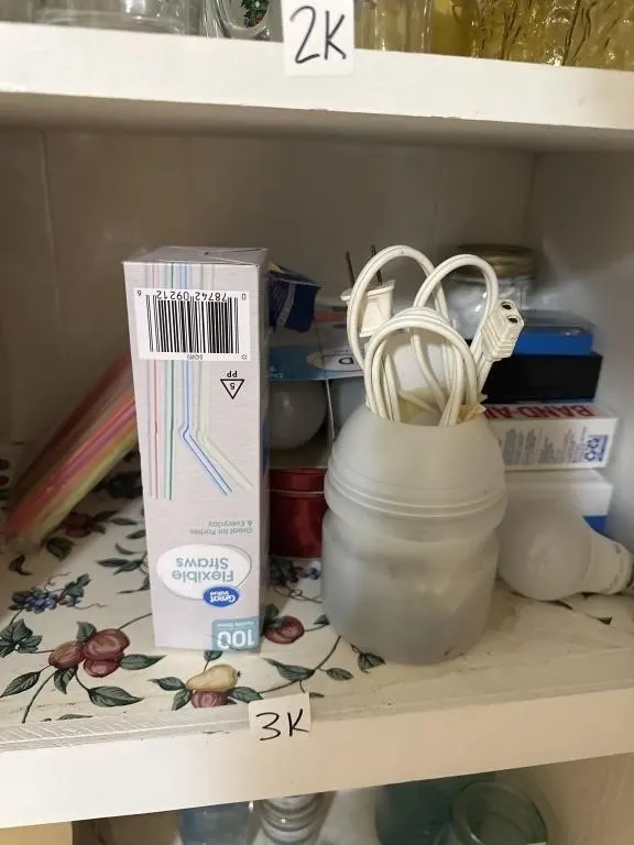 Cabinet lower shelf contents. Straws. Band aids