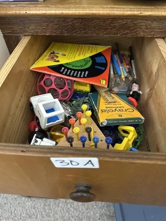 Drawer of pencils. Crayons . Small toys