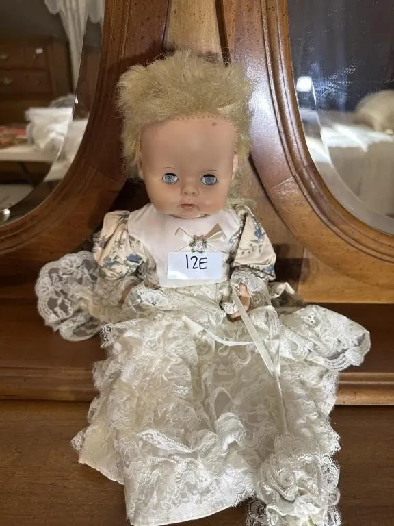 vintage doll with blonde hair and a beige,