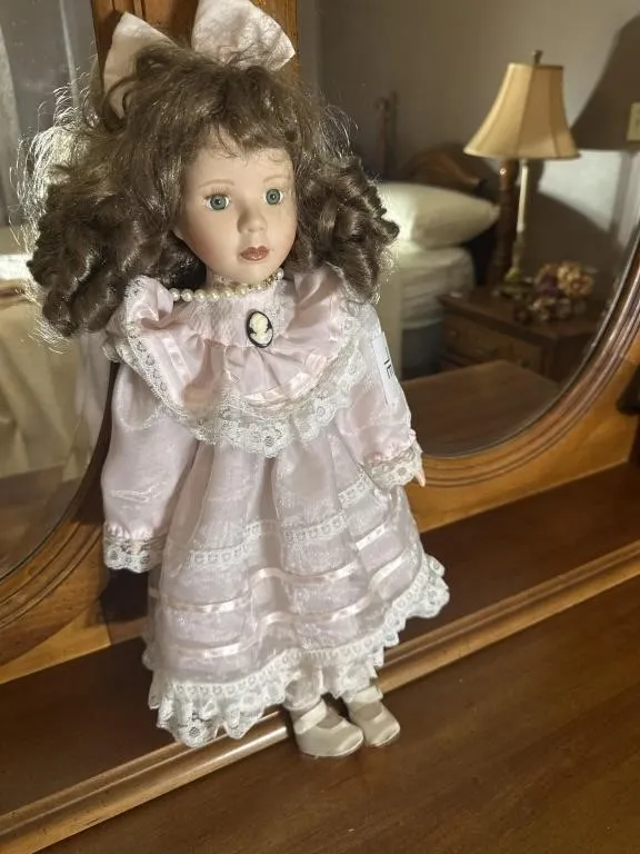 Brink�s porcelain doll with pink dress. 20 in t