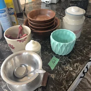assortment of pottery and wooden bowls