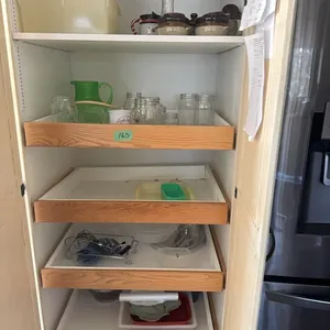 jars, tupperware- everything on shelves left of fridge.