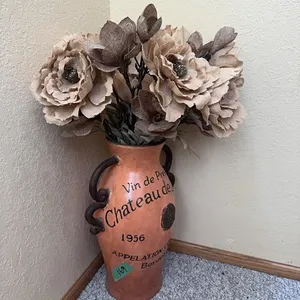 large spanish vase with flowers at bottom of basement steps
