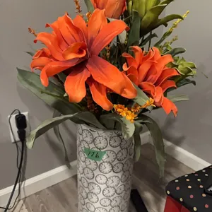 large vase with orange and green flowers