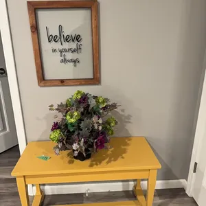 table, flowers, and wall hanging.. winning bid takes all