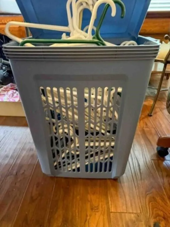 Hamper full of plastic hangers
