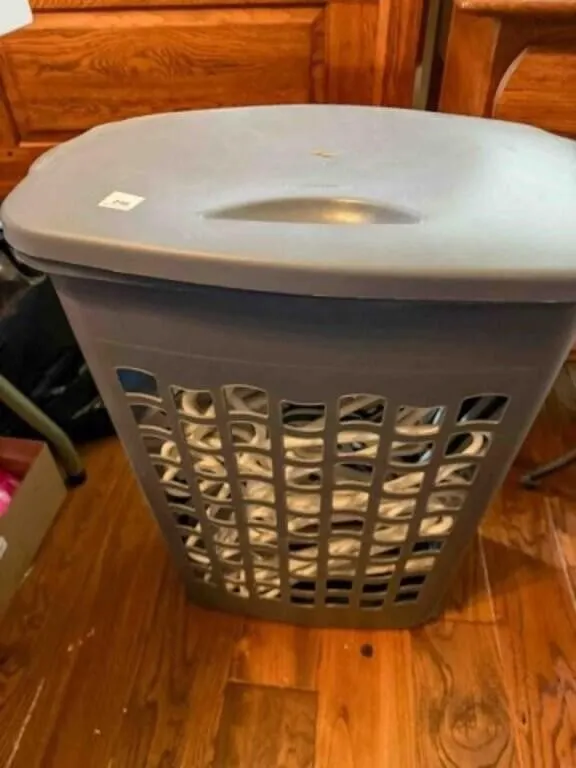 Hamper full of plastic hangers