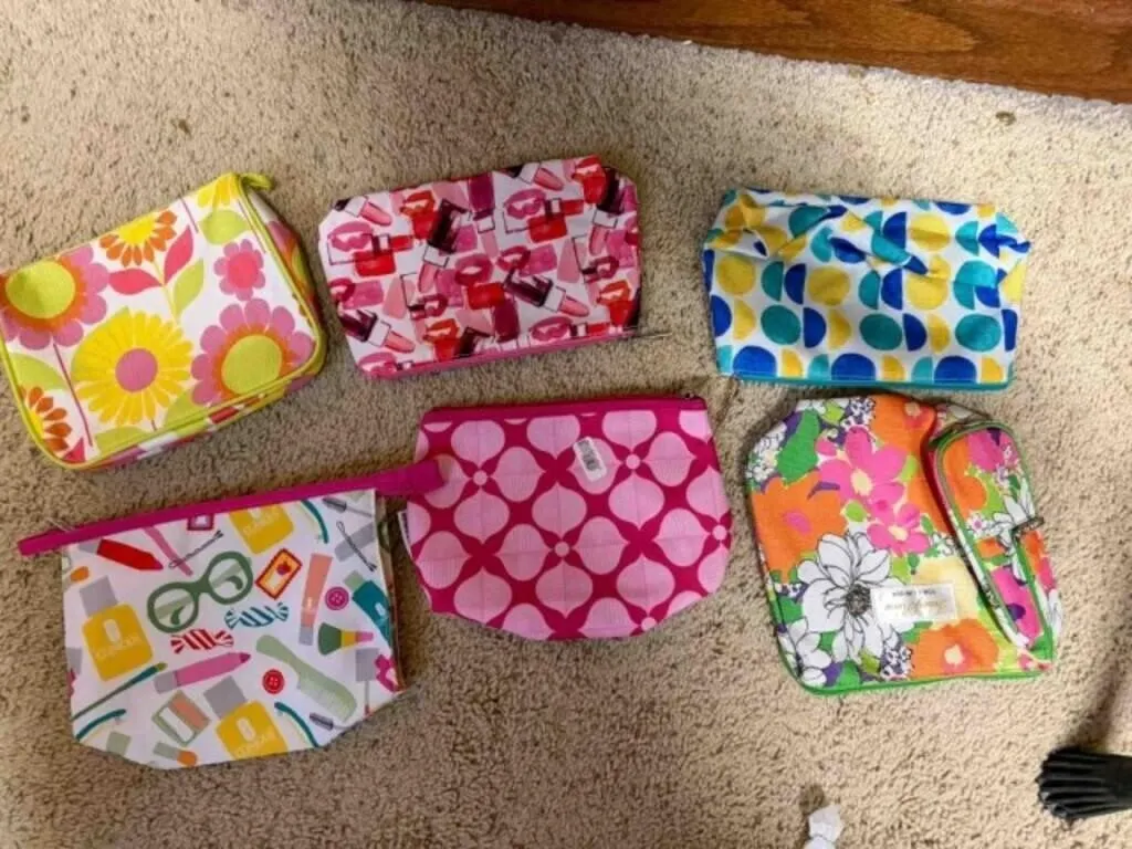 Box of ladies colorful makeup bags