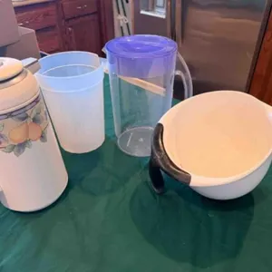 cabinet full of Ice maker, pitchers, etc