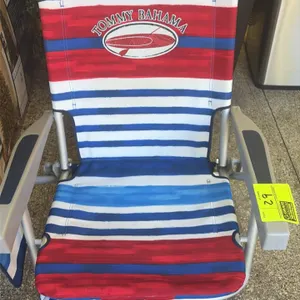 Tommy Bahama folding beach lawn chair. Features a red, white, and blue striped fabric design with Tommy Bahama branding. Constructed with a lightweigh