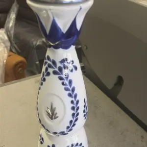A Collection of Empty Clase Azul Reposado Tequila Ceramic Bottles. (Clase Azul) A collection of empty hand-painted blue and white ceramic tequila deca