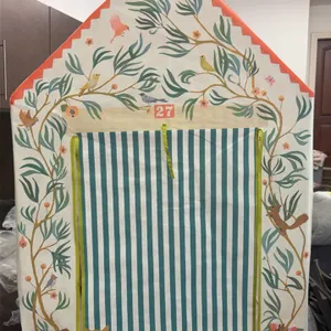 Kids playhouse. Features an illustrated fabric cover with garden and animal themes, a red and white striped roof, and roll-up door and window flaps. D