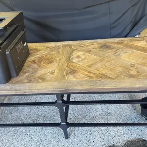 Wood top coffee table. Features a parquet-patterned wood top and a dark metal base. 54"L. Printer not included.