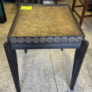 Decorative furniture set. Includes a wood end table featuring a black finish, textured gold-tone top with an overlapping circle pattern, and medallion