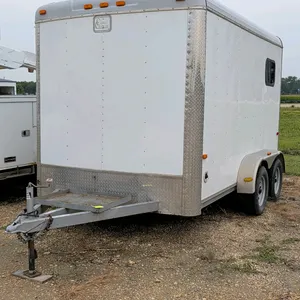 Cargo Craft Expedition enclosed bumper hitch trailer. Features twin axles, side walk-in door, rear single swing door, two windows, and two 16" square 